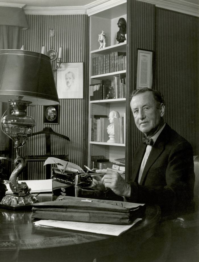 Ian Fleming at desk